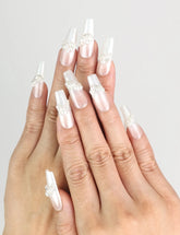 Hand wearing Starlight Singapore press on nails with white base and silver star designs by naillover